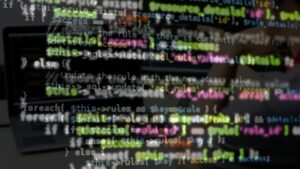 Computer Monitor Screen with Colorful Programming Code Lines Blurred Background Close Up